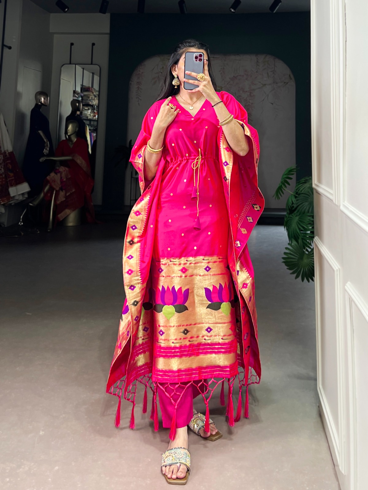 A vibrant pink jacquard kaftan with floral embroidery.