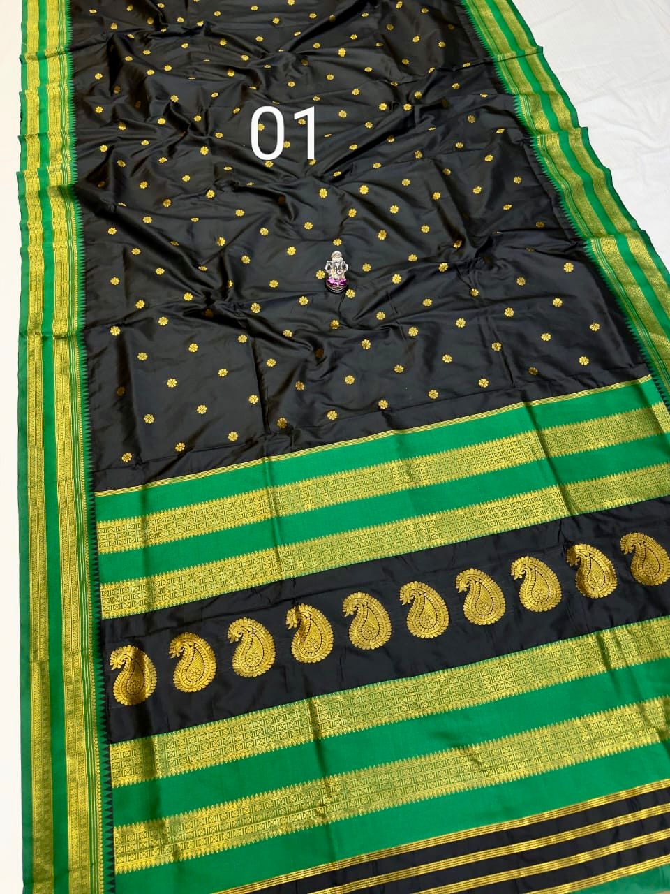 Black saree with green and gold accents for Makar Sankranti.