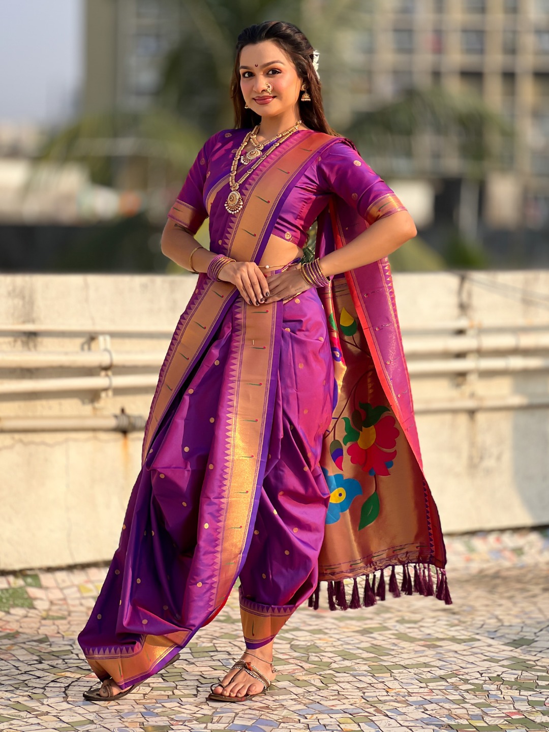 A vibrant purple Nauvari saree with zari work.
