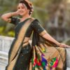 A woman wearing a green Nauvari saree with floral designs.