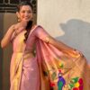 A woman wearing a pink Nauvari saree with floral designs.