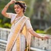 A woman wearing a Nauvari Saree with intricate patterns.