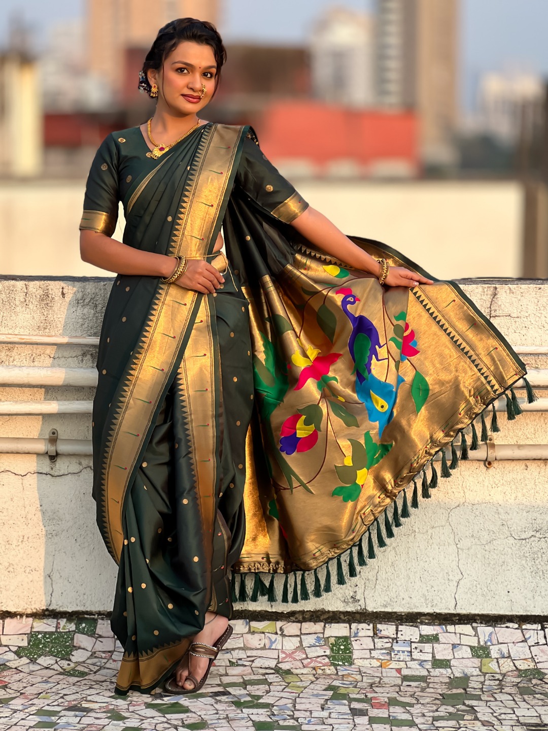 Dark green Nauvari saree with floral design.