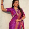 A woman wearing a purple Nauvari saree with intricate zari work.